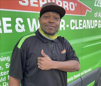 Male employee in front of service truck