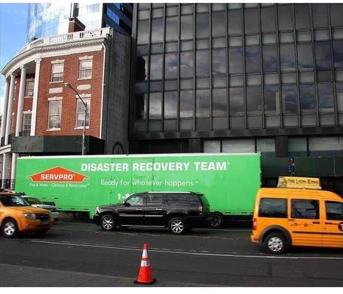SERVPRO disaster recovery truck parked in front of a high rise building 