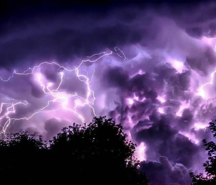 Lighting striking across a purple sky