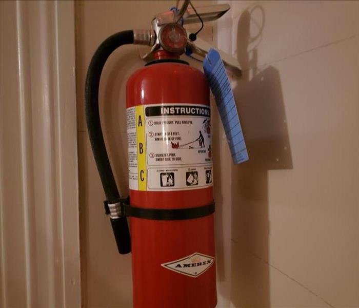 Fire extinguisher hanging on the wall of a building